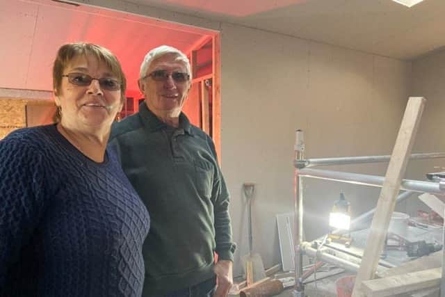 Jean and Kevin overseeing work at their home at Christmas.