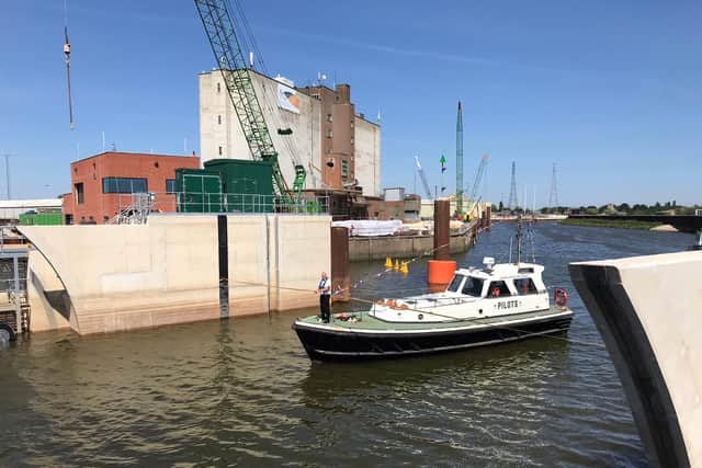 The pilot boat ceremonially cuts the ribbon as it passes the gates