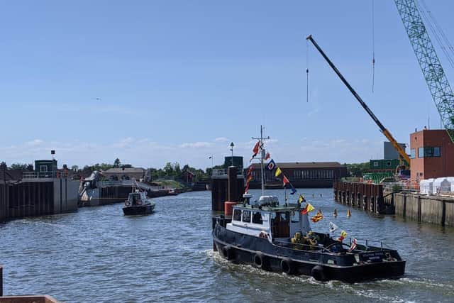 The Port of Bostons Pilot Cutter and the Boston Pride made the ceremonial first passage through the barrier gates