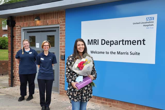 Sophie with some flowers and chocolates from Superintendent MRI Radiographer Fay Keegans (left) and MRI Radiographer Sally May (middle).
