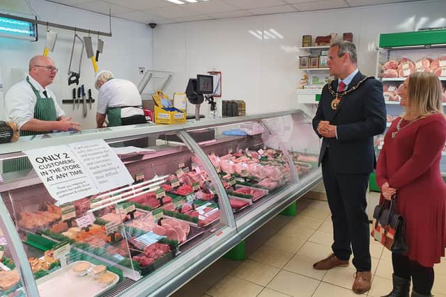 John Woolliss speaks with the Mayor at Woolliss & Son butchers.