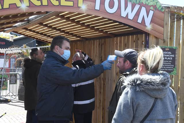 Visitors have their temperatures taken before being allowed on site.