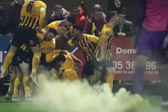 United celebrate scoring in their final FA Cup clash at York Street, a 2-1 defeat to Rochdale. Photo: Eric Brown