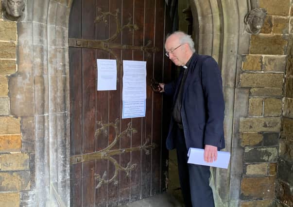 The Rev Charles Patrick opens the main door at St Mary's.