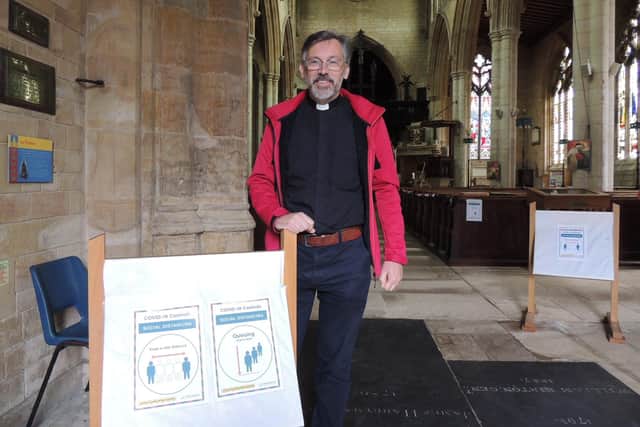 Rev Philip Johnson of St Denys Church with some of the signs for visitors. EMN-200622-162302001