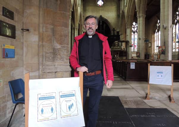 Rev Philip Johnson of St Denys Church with some of the signs for visitors. EMN-200622-162302001