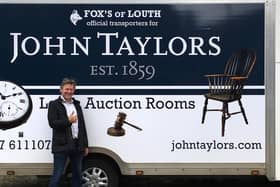 Auctioneer James Laverack with the new auction room transport.
