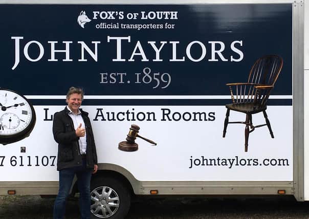 Auctioneer James Laverack with the new auction room transport.
