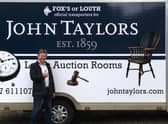 Auctioneer James Laverack with the new auction room transport.