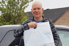 Age UK Chief Executive Officer Andy Storer with a 'Thinking of You' bag.
