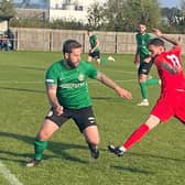 Sleaford's Joe Braithwaite looks to get past Melton Paul Anderson.