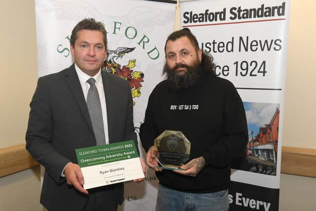 Ryan Blankley (right) receives the Overcoming Adversity Award from Stephen Tapley of sponsors William Alvey School. EMN-211015-095540001