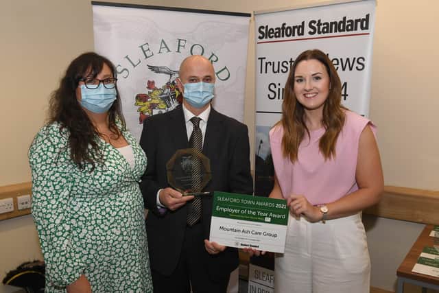 Jilly and Michael Hunt of Mountain Ash Care Group receive their Employer of the Year Award from sponsor Clear Round Media. EMN-211015-095604001