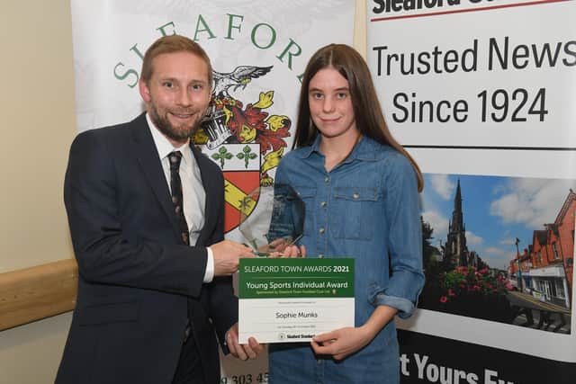 Jamie Shaw of sponsors Sleaford Town FC presents the Young Sports Individual Award to Sophie Munks. EMN-211015-095424001