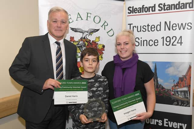 Daniel Harris and mum on behalf of his sister Imogen who won the Young Community Volunteer Award, presented by sponsors Sleaford Town FC. EMN-211015-095442001