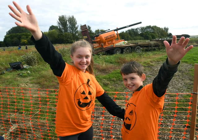 Natasha Doggett, 13, and Jack Doggett, 10, of Sleaford, watch the pumpkin cannon being fired. EMN-211018-102553001