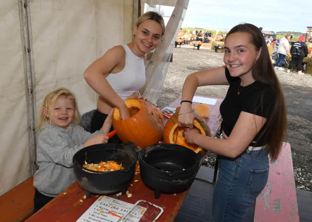 Trying out the pumpkin carving is Elland Tyzack-Morley, 4, Leah Sheldon and Briana Tyzack-Jackman, from Boston. EMN-211018-102442001