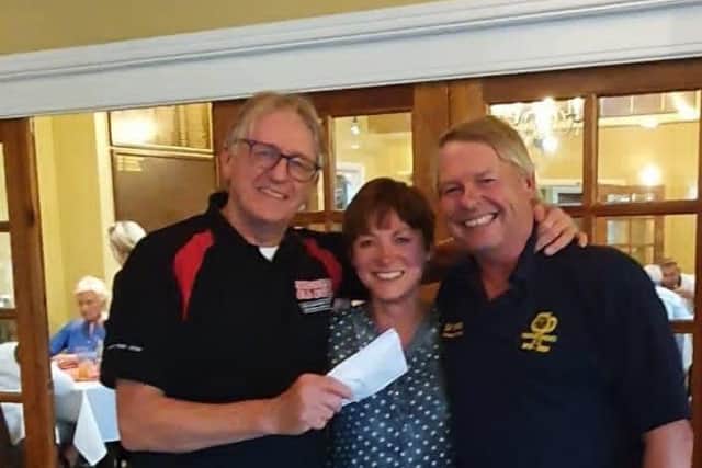 Sandra Watson with Rob Brooks and 'Pinchy' from Horseshoes Hockey Club presenting their donation of £600 to the RNLI. .