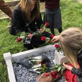 Alvey pupils laying flowers during Brian Fowler's memorial serrvice. EMN-211020-172700001