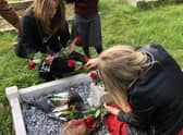 Alvey pupils laying flowers during Brian Fowler's memorial serrvice. EMN-211020-172700001
