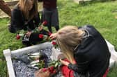 Alvey pupils laying flowers during Brian Fowler's memorial serrvice. EMN-211020-172700001