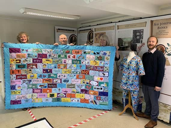 Horncastle History & Heritage Society archivist Mary Silverton and chairman Ian Marshman receive the special set of scrubs for the Town Archive from Tracey Leyland and Shelley Wills from Horncastle & District Scrubs. EMN-211025-112858001