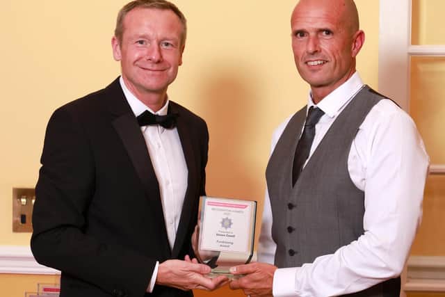 Simon Coxell (right) receiving his award.