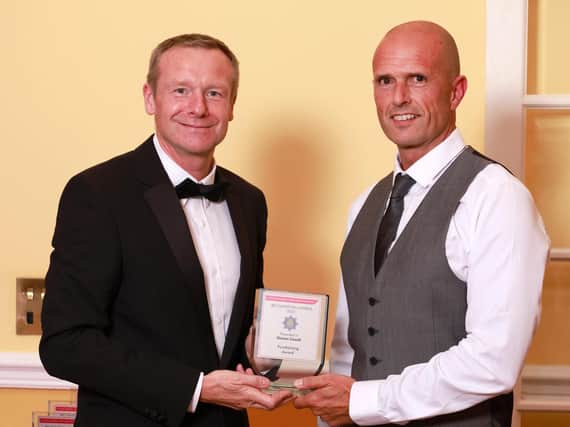 Simon Coxell (right) receiving his award.