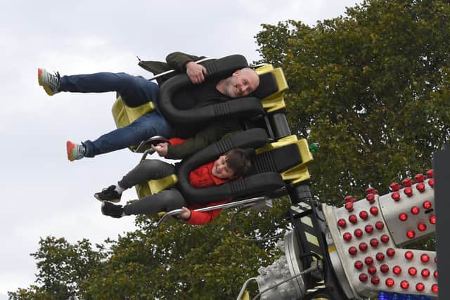 Christopher White and Byron White, nine, enjoy one of the rides at the fun fair in Boston.