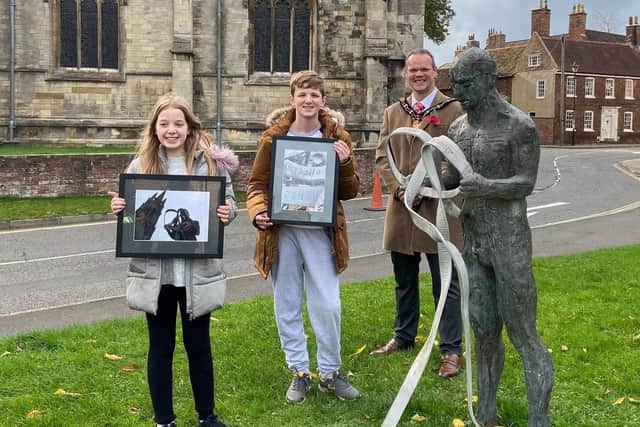 Rosa Gray and Harry Topham with their photographs, alongside the Mayor of Louth, Councillor Darren Hobson