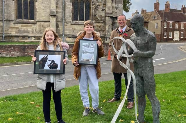 Rosa Gray and Harry Topham with their photographs, alongside the Mayor of Louth, Councillor Darren Hobson