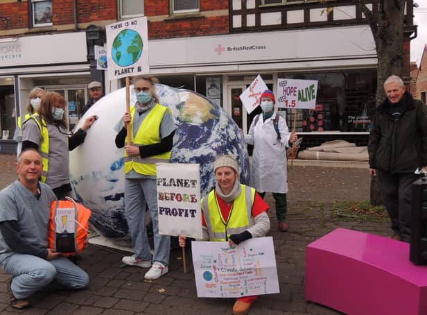 Sleaford Climate Action Network members stage their climate emergency performance near Handley Monument. EMN-210611-180252001