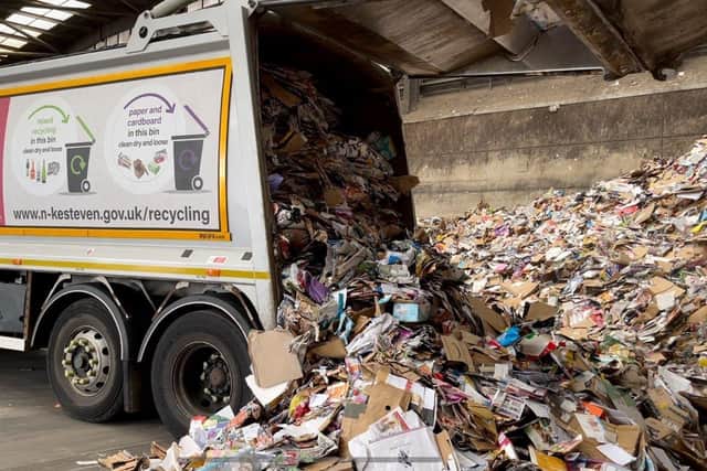 Dropping off paper and card from the purple-liidded bins at the depot. EMN-210311-170646001