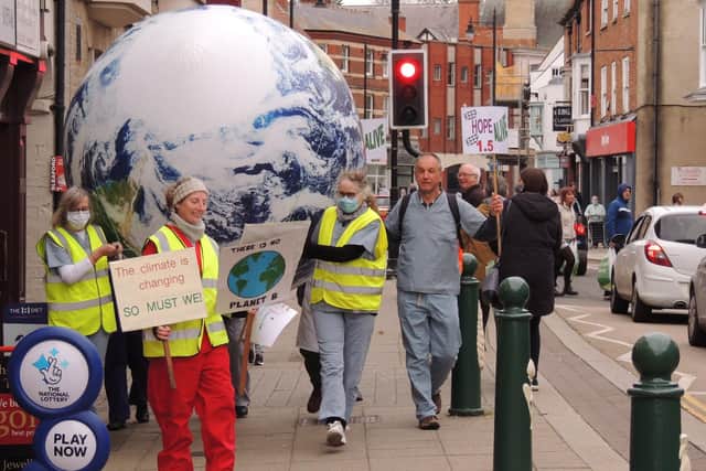 Sleaford Climate Action Network members stage their climate emergency performance, stretchering an ailing Earth along Southgate. EMN-210611-180303001