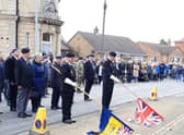 The standard bearers lower their flags at 11am. EMN-211115-092151001