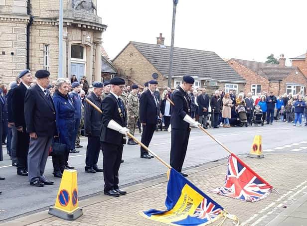 The standard bearers lower their flags at 11am. EMN-211115-092151001