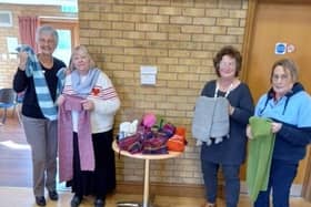 Leasingham WI pose with their scarves.