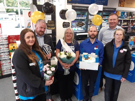 Sandra Taylor (centre)s last day at Co-op, from left: Sheryle Hay, Co-op regional manager Phil Waddington, store manager Adam Waddingham and general manager Craig Adamson. EMN-211011-121920001