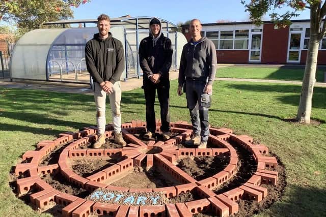 Builders Luke Pilkington, Carl Jupp and Charlie Matthews creating the Rotary Wheel.