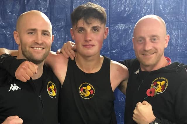 Boston ABC coaches Dennis Watson and Matthew Mooney pictured with Jamie Burgin after his victory on Saturday night.