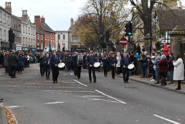 The Boy and Girls Brigade Band lead the procession out of Sleaford Market Place. EMN-211115-103411001
