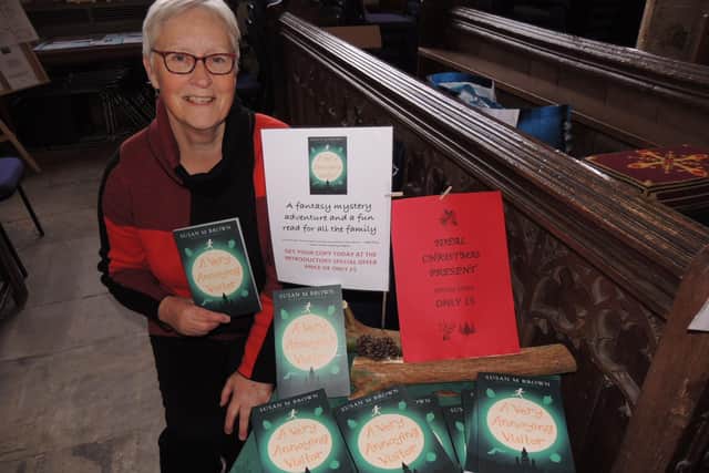 Debut author Susan M Brown of Great Hale with her first book, A Very Annoying Visitor, on sale at the Crafts By Candlelight fair at St Denis' Church, Silk Willoughby. EMN-210611-180715001