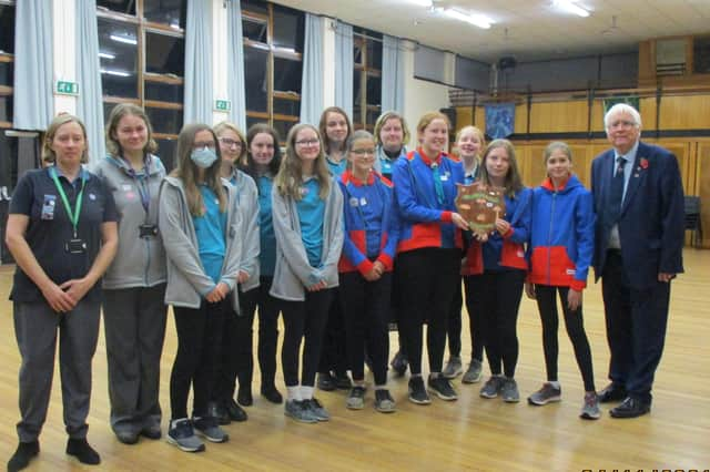 Guides and Rangers of the 4th Sleaford Company with Sir Bob Russell and the historic shield which he bought in an auction. EMN-211116-112909001