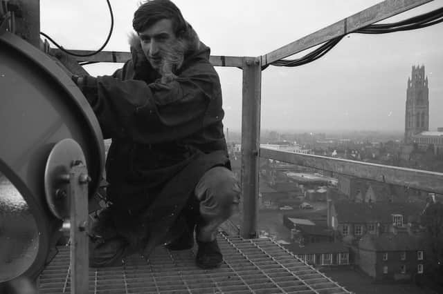 Work being carried out to the floodlights at York Street, with the Stump and Assembly Rooms visible in the background.