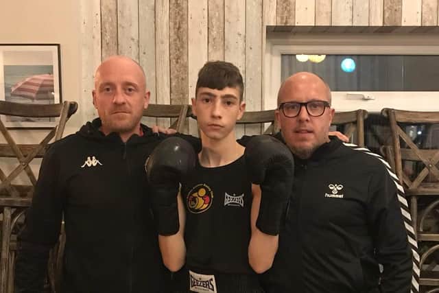 Harley Butterfield with club coaches Matthew Mooney and Mark Crozier.