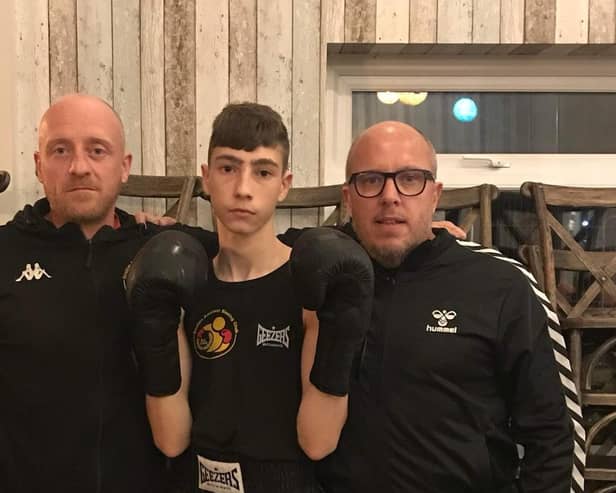 Harley Butterfield with club coaches Matthew Mooney and Mark Crozier.