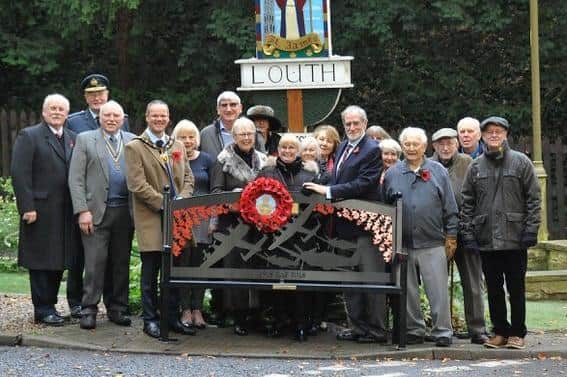 The Mayor of Louth, Councillor Darren Hobson; Rotary Club president, Rob Hall; Air Vice Marshall (Retired) Martyn Gardiner, and ex-Red Arrow Alan Chandler alongside the new bench and the members of the public who attended