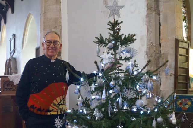 The Rev Chris Hewitt with one of the trees at the last festival in Tealby EMN-211125-104816001