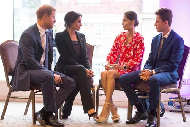 Evie meeting Prince Harry and Meghan Markle alongside her brother Rocco after winning an Inspirational Child award.