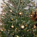 Carole Harbon decorating the Christmas tree donated by Bell's of Bennington for the Wainfleet Methodist Church Christmas Tree Festival and the  Christmas Community Feast.